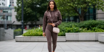 Woman in cropped hoodie and high-waisted leggings, urban athleisure style